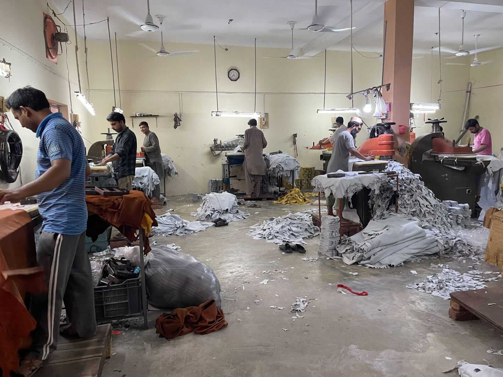 Workers cutting leather in the cutting department