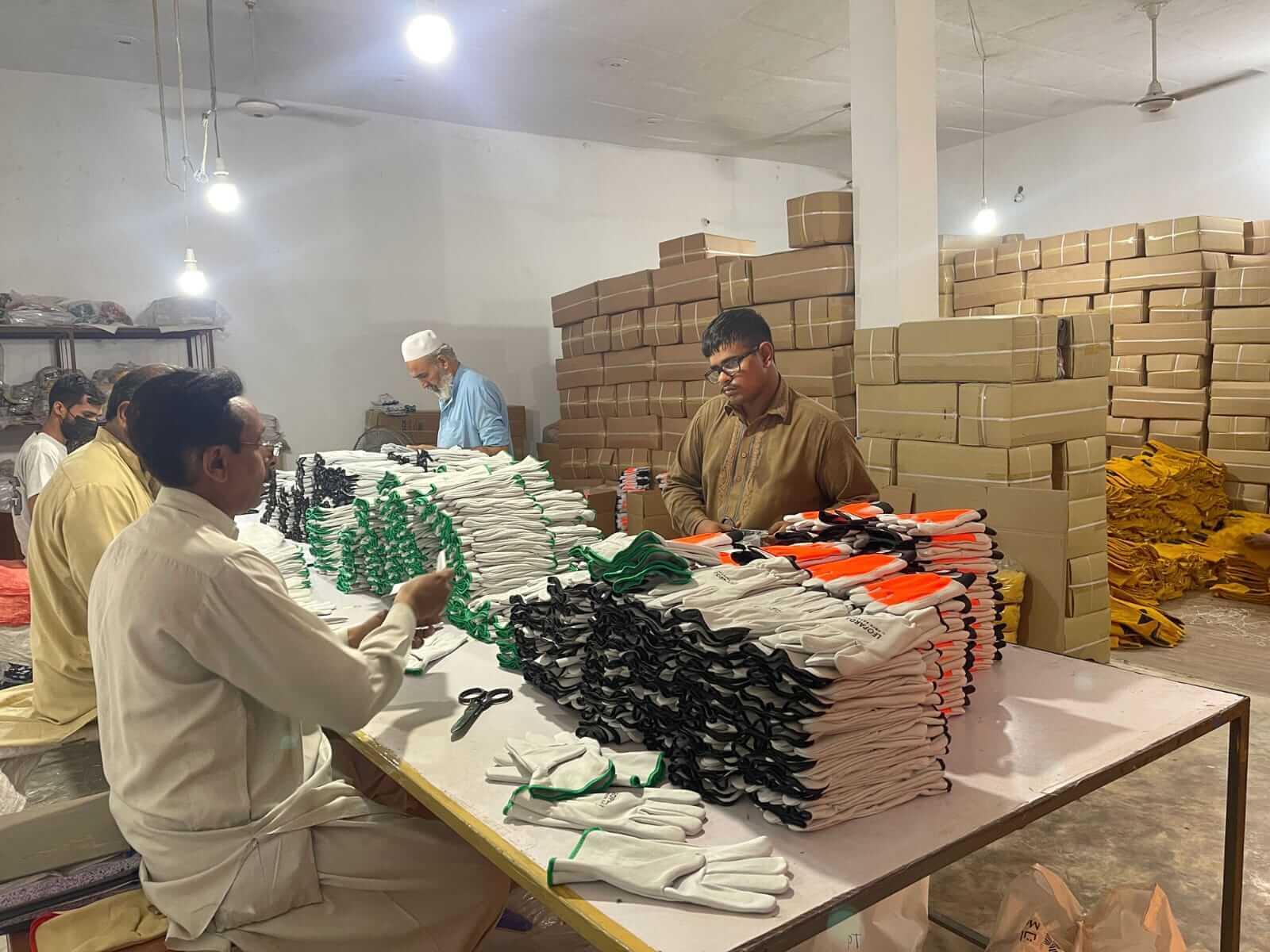 Worker examining finished leather products for quality